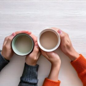 カップを持つカップルの手